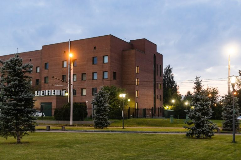 green lawn and building illuminated by lantern